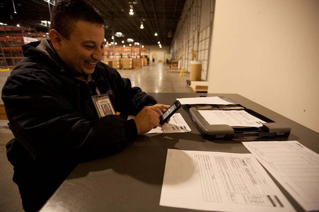 Morgan team member reviewing shipment details on a tablet