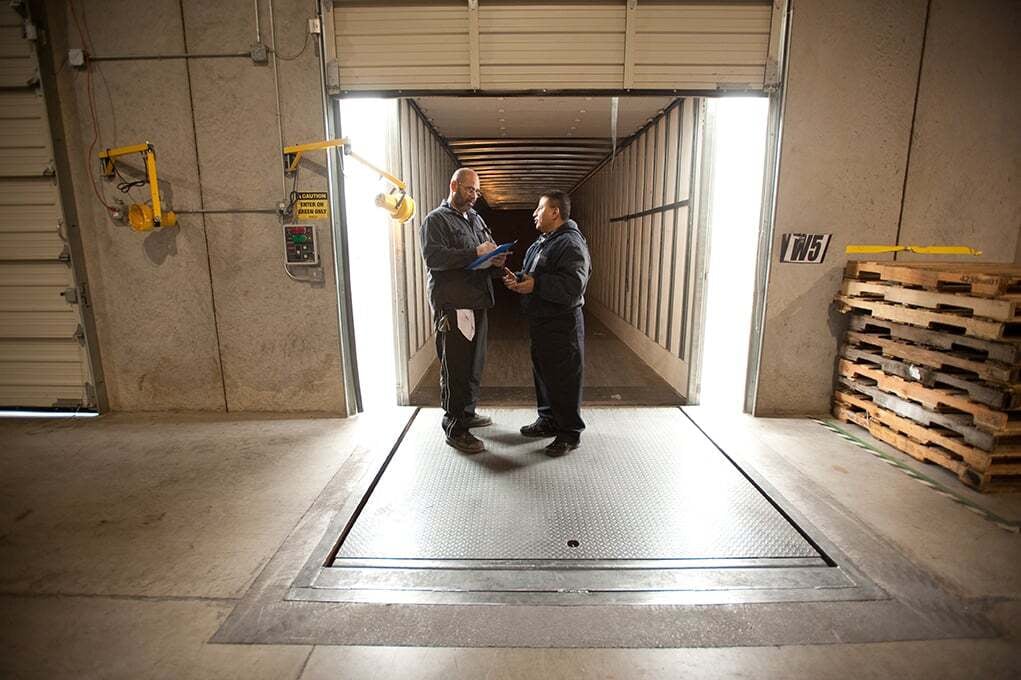 Two Morgan team members coordinating at a loading dock